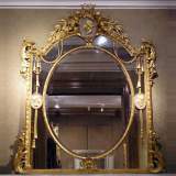 Gilded trumeau with medallions and putti - Reference 9388 Width 5' 6'' ⅛ Height 6' 4'' ¾ Gilded trumeau with medallions and putti - Reference 9388 Width 5' 6'' ⅛ Height 6' 4'' ¾