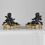 Pair of Andirons with Cherubs Warming Themselves by the Fire