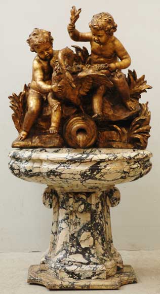 Gilded garden fountain with putti and swan