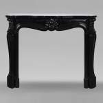 Louis XV style mantel in fine black Belgian marble decorated with a shell framed with buds