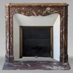 Pompadour mantel in the Louix XV style, carved in Northern red marble