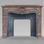 Louis XV style mantel in Rouge du Nord marble adorned with a shell motif