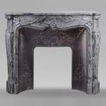 Louis XV style mantel adorned with a carved shell in Bleu Fleury marble