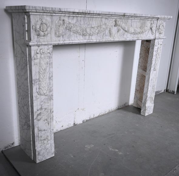 Louis XVI period mantel adorned with a garland carved in antique veined Carrara marble-5