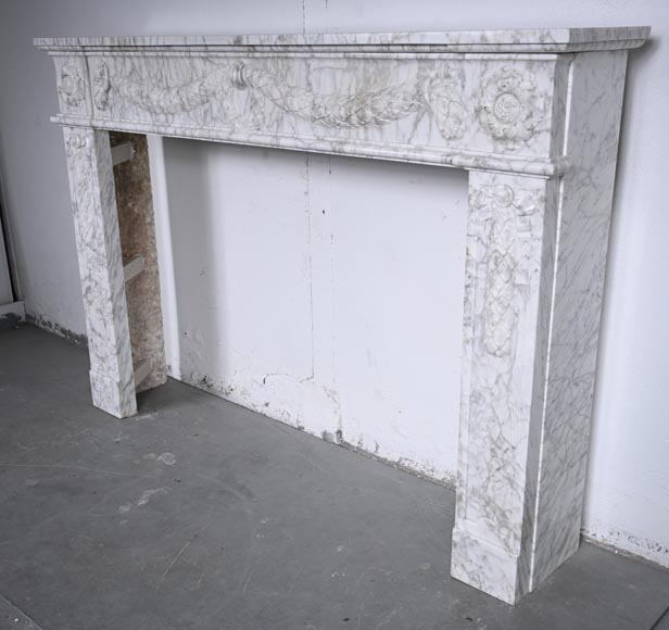 Louis XVI period mantel adorned with a garland carved in antique veined Carrara marble-9