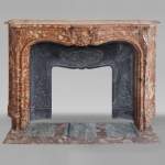 Louis XV style red marble mantel with curved sides and shell flowers