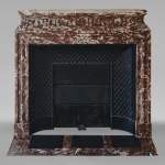 Louis XIV style mantel with acroterion in Rouge du Nord marble