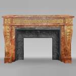 Large Louis XVI style mantel in red breche marble adorned with bronze.