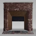 Louis XIV style mantel with acroterion in Rouge du Nord marble