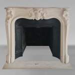 Louis XV style stone mantel with asymmetrical shell design