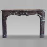 Louis XV period fireplace with molded entablature, in Campan marble